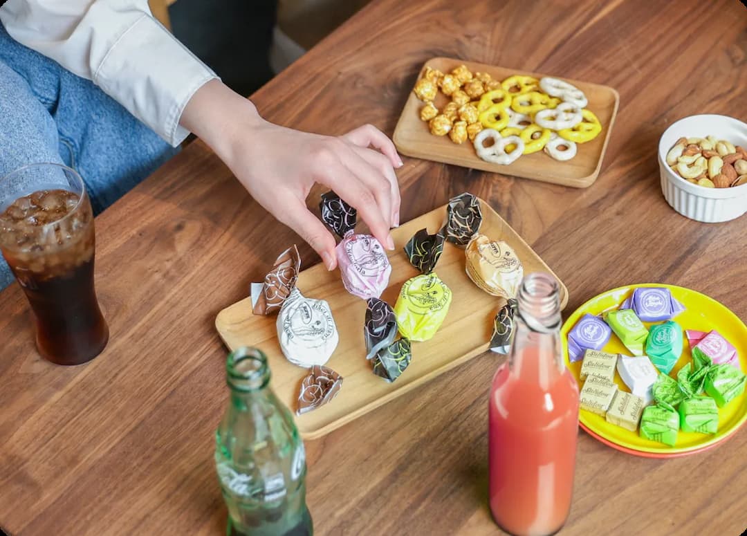 大量の飲み物やお菓子がテーブルの上に無造作に置かれている写真